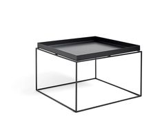 a black square table with a metal frame and tray on the top, against a white background