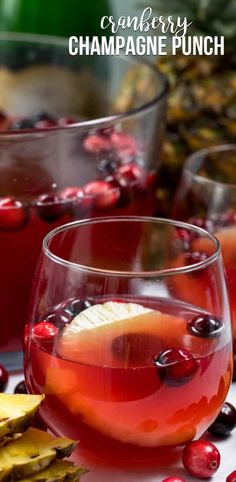 cranberry champagne punch is served in glasses with garnishes on the side