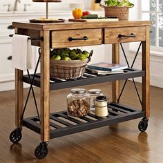 a kitchen island cart with two drawers and baskets on the top, in front of a counter