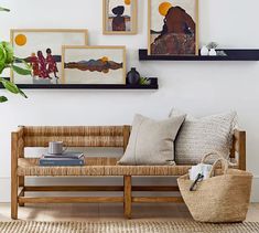 a living room with pictures on the wall and a couch in front of some books