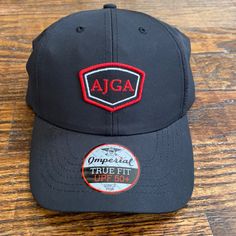 Imperial Branded Golf Hat. Velcro Closure. 100% Polyester. Black Six-panel Golf Hat, Black Curved Brim Baseball Cap For Golf, Black Golf Hat With Curved Brim, Black Adjustable Hats For Golf, Black Cap For Golf, Adjustable Black Hat For Golf, Adjustable Black Golf Hat, Black Snapback Golf Hat, Black Snapback Hat For Golf