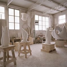 a room filled with lots of white sculptures