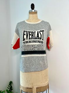 1980s Everlast Training Work-out gray, red, black and white colorblock short sleeve sweatshirt. The fabric of this sweatshirt is worn to perfection, making it really soft! Some discolorations consistent with age on sleeves is pictured. In otherwise very good vintage condition size M/L - smaller size will fit oversized  B: 44" W: 42" L: 23" Everlast Clothing, Short Sleeve Sweatshirt, Training Shorts, Work Out, Crewneck Sweatshirt, Color Blocking, Color Block, Sweat Shirt, Crew Neck Sweatshirt