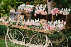 an old wooden cart with flowers and pictures on the back is set up for a wedding