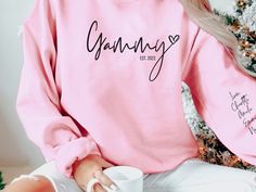 All Grandmas will love this cute Grandma sweatshirt with grandkids names printed on the sleeve!  *Enter Term for front of shirt *Enter Est. date for front of shirt *Enter children's names for sleeve *Example:  Grandma, 2022, Emma, David, Ali, Rebecca * 50% cotton, 50% polyester * Pre-shrunk * Classic fit * 1x1 athletic rib knit collar with spandex * Air-jet spun yarn with a soft feel and reduced pilling * Double-needle stitched collar, shoulders, armholes, cuffs, and hem * Wash inside out in coo Long Sleeve Tops With Name Print For Family, Personalized Pink Casual Sweatshirt, Casual Personalized Pink Tops, Casual Personalized Pink Top, Customizable Long Sleeve Pink Top, Personalized Casual Crew Neck Tops, Personalized Long Sleeve Casual T-shirt, Casual Personalized Long Sleeve T-shirt, Personalized Casual Long Sleeve T-shirt