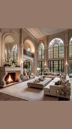 a large living room with high ceilings and arched windows