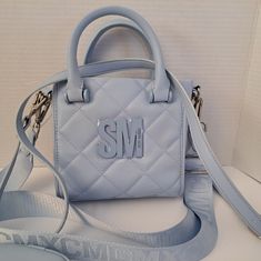 Steve Madden Bbabi Satchel Crossbody Bag/Air Pod Case. Sky Blue. A Bold Initial Logo Sachel. 2 Detachable Straps And A Top Handle. Cute, Small, And Stylish. 1 Zipper Pocket Inside. Leather Strap Bag, Air Pod, Blue Purse, Luxury Purses