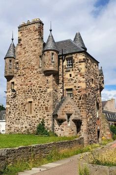 an old stone castle with turrets and windows