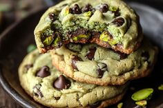 chocolate chip cookies with pistachios and pistachio on the top one is half eaten