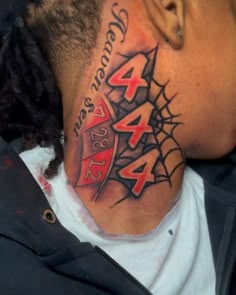 a man with a spider web tattoo on his neck