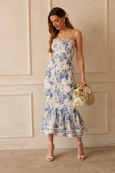 The Geranium dress is a fitted floral midi dress perfect for any garden party! She is made with elastic ruching for easy fit and comfort. She is accented with ruffles all the way down and finished with a gathered flounce at the hem. She is made in our Provencal Blue Floral printed organza and lined with a cotton jersey for a soft inside touch. The Geranium dress fits similar to the Lily dress. She is super stretchy, so you can go up or down in sizing and it will fit. Bregje is 5'9.5 and is weari Geranium Dress, V Chapman, Outfit Elegantes, Printed Organza, Garden Party Dress, Feminine Outfit, Guest Outfit, Floral Midi Dress, Dress Ideas