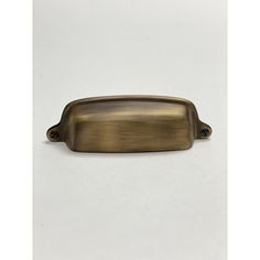 an antique brass drawer pull handle on a white background with clipping for text or image