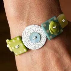 a close up of a person's wrist wearing a bracelet with buttons on it