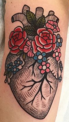 a heart tattoo with flowers on it