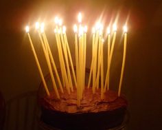 a chocolate cake with lit candles on it