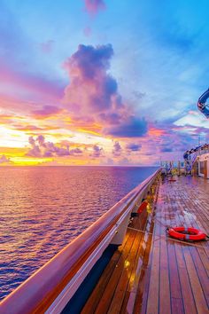 the deck of a cruise ship at sunset with life vests laying on it's side