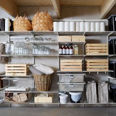 the shelves are organized with baskets, bottles and other items