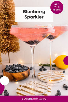 blueberry sparkler cocktail in coupe glasses with berries on the rim