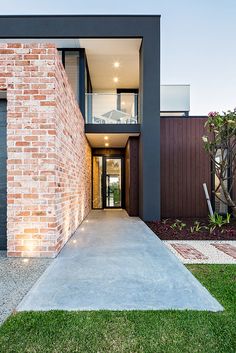 a modern house with brick and glass walls