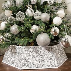 a christmas tree with silver and white ornaments