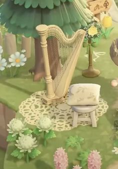 a harp sitting on top of a lush green field next to a white flower covered bench