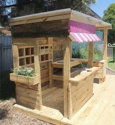 a wooden structure with plants growing out of the top and bottom shelves on each side