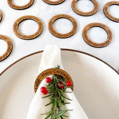 a white plate topped with a napkin covered in greenery next to plates filled with cookies