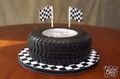 a cake made to look like a tire with checkered flags on top