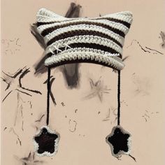 a crocheted hat hanging from the side of a wall