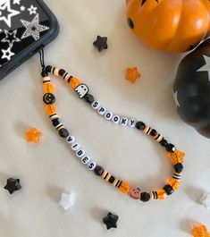 a halloween beaded bracelet with the word boosie on it next to some decorations