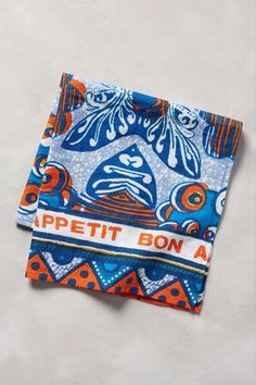 an orange and blue patterned napkin with the words appetit bona on it