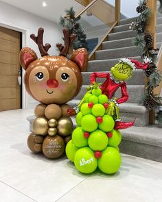 an inflatable christmas tree next to a statue of a teddy bear and elf