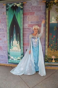 there is a statue of a woman dressed as frozen queen in front of a castle