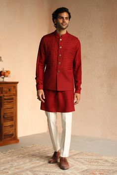 Crab red wool embroidered bundi in geometric thread work. Paired with solid kurta.
Component: 2
Pattern: Embroidered
Type Of Work: Thread work
Neckline: Mandarin collar
Sleeve Type: Full sleeves
Fabric: 100% Wool
Color: Red
Other Details: 
Welt pocket
Note: Dupatta and pant worn by the model is not for sale
Occasion: Reception - Aza Fashions Mens Evening Wear, Nehru Jacket For Men, Red Kurta, Kurta Patterns, Kurta Men, Kurta Set For Men, Formal Mens Fashion, Luxury Wear, Red Thread