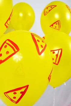 some yellow balloons with red designs on them