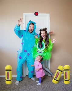 a man and woman in costumes standing next to a child