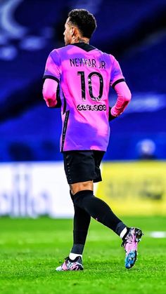 the soccer player is wearing pink and black