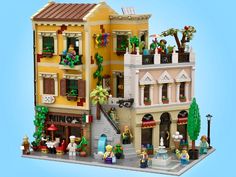 a lego model of a building with lots of windows and balconies on it