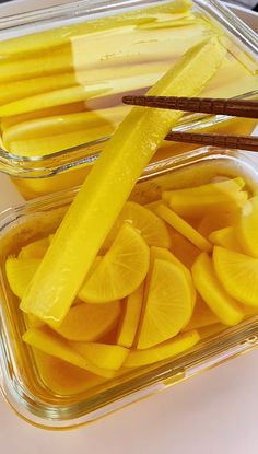 sliced lemons in plastic containers with chopsticks