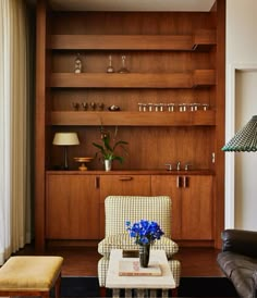 a living room filled with furniture and wooden shelves