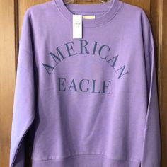 American Eagle Sweatshirt Size Medium Brand New With Tags Comes From A Smoke Free Home Purple Letter Print Sweatshirt, Casual Purple Sweatshirt With Letter Print, Purple Letter Print Sweater For Fall, Casual Purple T-shirt For Winter, Purple Letter Print Sweatshirt For Spring, Purple Letter Print Top For Fall, Purple Letter Print Tops For Loungewear, American Eagle Sweater Hoodie, Dark Green Hoodie