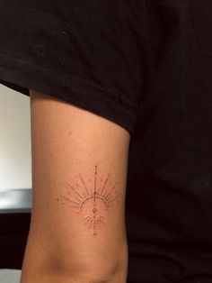 a woman's arm with a tattoo on it that shows the sun and stars