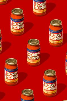 many canned food items are on a red surface with the words sorry nonna in white letters