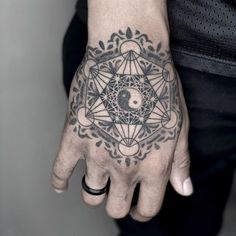 a person's hand with a tattoo on it