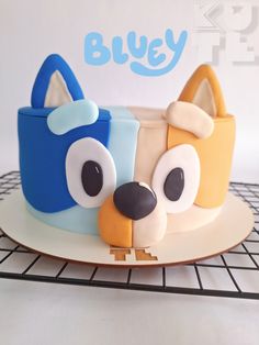 a cake that looks like a dog with big eyes on it's face and nose