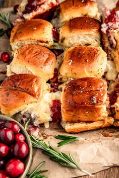 cranberry and rosemary sliders on parchment paper with fresh cranberries in the background