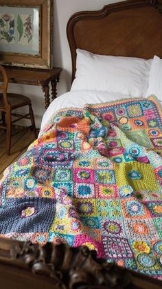 a crocheted blanket on top of a bed