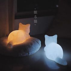 a cat shaped light sitting on top of a pillow