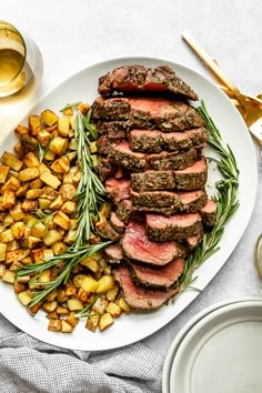 a white plate topped with steak and potatoes