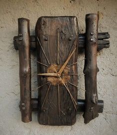 a clock made out of wood sticks and nails on the side of a building wall